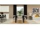 Bright dining area with a modern table, six chairs, stylish lighting, and a view of the backyard at 16962 Warm Hand Ct, Land O Lakes, FL 34638