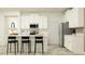 Open kitchen featuring white cabinetry, stainless steel appliances, and an island with seating for casual dining at 16962 Warm Hand Ct, Land O Lakes, FL 34638