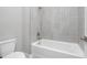 Bathroom featuring a white soaking tub with chrome fixtures and tiled wall at 17404 Nokota Ave, Hudson, FL 34667