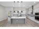 Modern kitchen with white cabinets, stainless steel appliances, and a large center island at 17404 Nokota Ave, Hudson, FL 34667