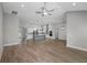 Open-concept living space flowing into a modern kitchen with hardwood floors at 17404 Nokota Ave, Hudson, FL 34667