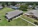 Aerial view of single story homes with mature landscaping, sidewalks, and green lawns at 1904 Canterbury Ln # 18, Sun City Center, FL 33573