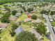 Aerial view of a well-maintained community with lush greenery, mature trees, and various housing units at 1904 Canterbury Ln # 18, Sun City Center, FL 33573