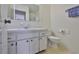 Well-lit bathroom with vanity, mirror, and toilet, exuding cleanliness and comfort at 1904 Canterbury Ln # 18, Sun City Center, FL 33573