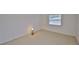 A light and airy bedroom with neutral carpet and walls featuring a whimsical lamp at 1904 Canterbury Ln # 18, Sun City Center, FL 33573