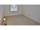 Simple bedroom design with carpeted floors and a window view, exuding comfort at 1904 Canterbury Ln # 18, Sun City Center, FL 33573