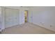 A bright bedroom features neutral carpet, a spacious closet, and a bathroom doorway at 1904 Canterbury Ln # 18, Sun City Center, FL 33573