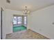 Bright dining room featuring a modern chandelier and convenient access to a screened-in patio at 1904 Canterbury Ln # 18, Sun City Center, FL 33573