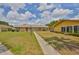 Charming exterior featuring a neatly maintained lawn and walkway to the colorful red front door at 1904 Canterbury Ln # 18, Sun City Center, FL 33573