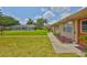 A serene view of multiple homes, each with verdant lawns, charming walkways, and inviting front doors at 1904 Canterbury Ln # 18, Sun City Center, FL 33573