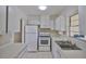 Clean and bright kitchen with white cabinets, appliances, and countertops, offering a functional cooking space at 1904 Canterbury Ln # 18, Sun City Center, FL 33573