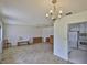 Spacious living room features plank flooring, chandelier, and direct access to the kitchen at 1904 Canterbury Ln # 18, Sun City Center, FL 33573