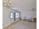 Bright living room with plank flooring and direct access to outdoor patio with screen door at 1904 Canterbury Ln # 18, Sun City Center, FL 33573
