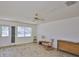 Bright living room featuring wood-look floors, ceiling fan, and natural light from the window at 1904 Canterbury Ln # 18, Sun City Center, FL 33573