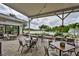 The covered patio area has seating and views of the pond and sprinkler at 1904 Canterbury Ln # 18, Sun City Center, FL 33573