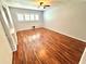 Bedroom featuring hardwood floors, ceiling fan, and plantation shutters at 2262 Swedish Dr # 6, Clearwater, FL 33763