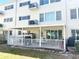 Private patio with an awning and white railing, offering a relaxing outdoor space with furniture and a grill at 2262 Swedish Dr # 6, Clearwater, FL 33763