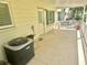 A spacious patio with a unit air conditioning system present and a view of foliage beyond the railing at 2262 Swedish Dr # 6, Clearwater, FL 33763