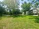 Expansive green yard surrounded by mature trees and landscaping at 2262 Swedish Dr # 6, Clearwater, FL 33763