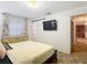 Comfortable bedroom featuring a sliding door, a built-in tv, and a window at 27315 Popiel Rd, Brooksville, FL 34602