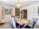 Stylish dining room with a modern table setting, elegant chandelier, and view to living room at 27315 Popiel Rd, Brooksville, FL 34602
