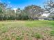 Exterior view of the home showcasing its spacious lot and appealing landscaping, including mature trees at 27315 Popiel Rd, Brooksville, FL 34602
