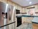 Charming kitchen with stainless steel refrigerator, black appliances, and ample counter space at 27315 Popiel Rd, Brooksville, FL 34602