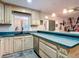Well-appointed kitchen featuring a breakfast bar, stainless steel dishwasher, and ample counter space at 27315 Popiel Rd, Brooksville, FL 34602