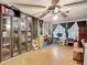 Versatile room with display cabinet, ceiling fan, natural light, and ample space for varied activities at 27315 Popiel Rd, Brooksville, FL 34602