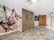 Spacious living room showcasing unique wall art and open floor plan with view to front door at 27315 Popiel Rd, Brooksville, FL 34602