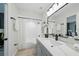 Modern bathroom with white subway tile, grey vanity and black fixtures at 3004 Conifer Dr, Largo, FL 33771