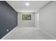 Neutral bedroom with an accent wall, large window, and closet at 3004 Conifer Dr, Largo, FL 33771