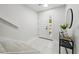 Bright entryway with white tile, a modern table, and staircase at 3004 Conifer Dr, Largo, FL 33771