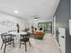 Open-concept living room, dining space showcasing a modern table set, and access to the backyard at 3004 Conifer Dr, Largo, FL 33771