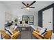 Stylish living room with modern furnishings, a ceiling fan, and sliding glass doors leading to backyard at 3004 Conifer Dr, Largo, FL 33771