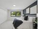Cozy main bedroom with a large window, closet, and contemporary decor at 3004 Conifer Dr, Largo, FL 33771