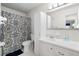 Neutral bathroom with a tiled shower, vanity with sink and mirror, and cabinet at 3114 59Th S St # 203, Gulfport, FL 33707