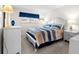Cozy bedroom featuring a comfortable bed with striped bedding, white nightstands, and natural light at 3114 59Th S St # 203, Gulfport, FL 33707
