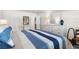 Neutral bedroom featuring a comfortable bed, dresser with mirror, and ample closet space at 3114 59Th S St # 203, Gulfport, FL 33707