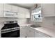 Bright kitchen featuring white cabinets, modern appliances, and a sink with a view, perfect for home cooking at 3114 59Th S St # 203, Gulfport, FL 33707