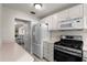 Charming kitchen with white cabinets, stainless steel appliances, and ample counter space, perfect for cooking enthusiasts at 3114 59Th S St # 203, Gulfport, FL 33707