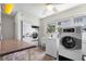 Community laundry room featuring multiple washers and dryers, utility sink, and table at 3114 59Th S St # 203, Gulfport, FL 33707