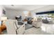 Bright and airy living room with tile floors, comfortable seating, and a view of the dining area, perfect for relaxation at 3114 59Th S St # 203, Gulfport, FL 33707