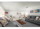 Bright living room featuring modern sofas, neutral tile floors, and tasteful decor and furnishings at 3114 59Th S St # 203, Gulfport, FL 33707