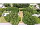 Aerial view of a tree-lined property, including both the main house and outbuildings at 38839 Miller Ave, Zephyrhills, FL 33542