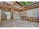 Basement with unfinished floor and walls, built-in shelving, with laundry area at 38839 Miller Ave, Zephyrhills, FL 33542