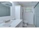 Bathroom with shower, white vanity, sink, toilet and medicine cabinet in neutral tones at 38839 Miller Ave, Zephyrhills, FL 33542