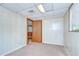 Bedroom featuring a doorway, wood paneling, carpet and a window at 38839 Miller Ave, Zephyrhills, FL 33542