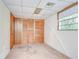 Bedroom featuring a closet with wood sliding doors, carpet and wood paneling at 38839 Miller Ave, Zephyrhills, FL 33542