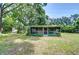 Exterior view of house featuring screened-in porch and green lawn at 38839 Miller Ave, Zephyrhills, FL 33542